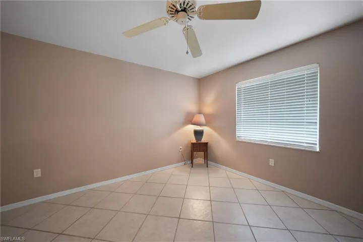 Bedroom 2, Unfurnished room featuring light tile patterned floors and ceiling fan