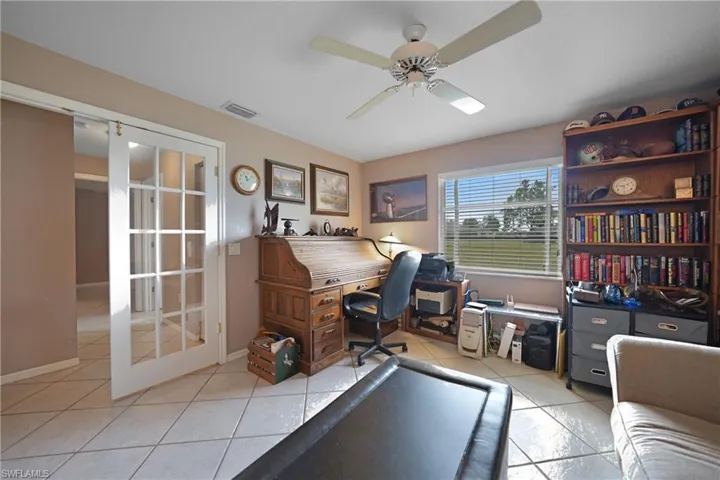 Office featuring ceiling fan, light tile patterned floors, and french doors