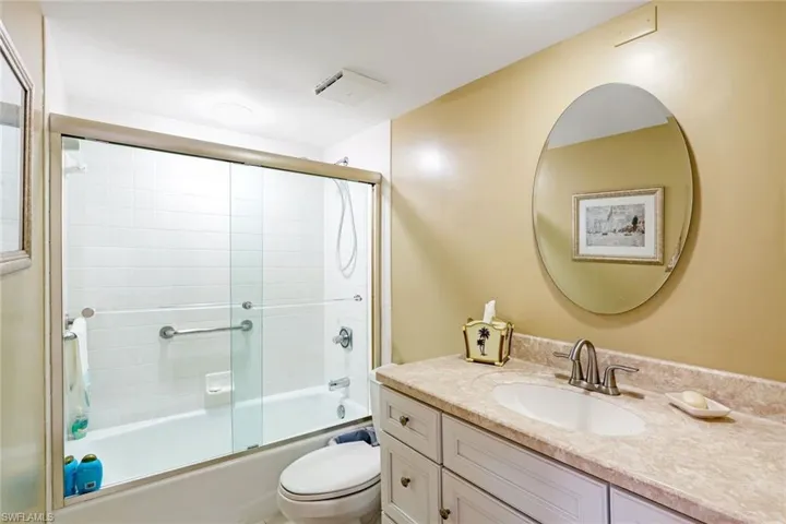 Full bath with vanity and shower / bath combination with glass door