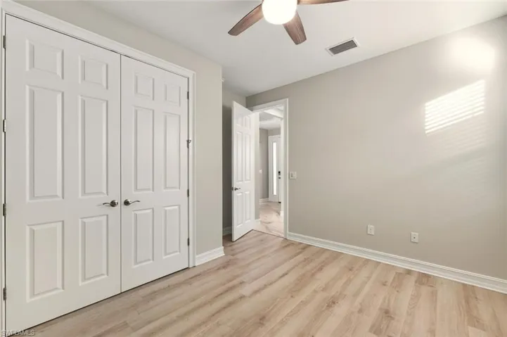 Unfurnished bedroom with a closet, light wood-style floors, and ceiling fan