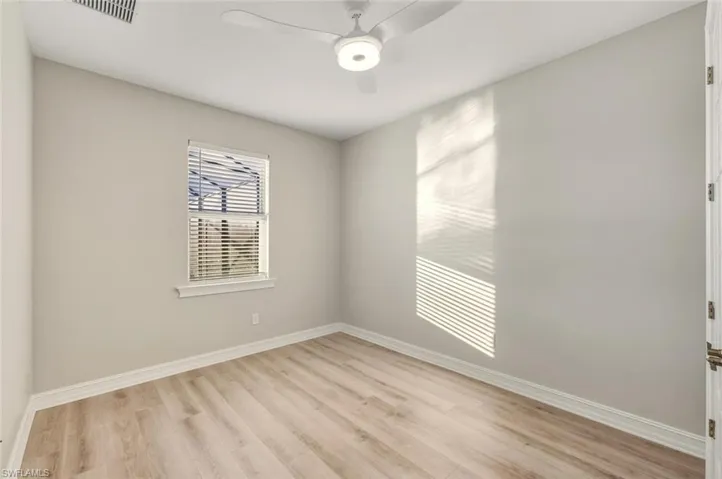 Unfurnished room featuring ceiling fan and light wood-style floors
