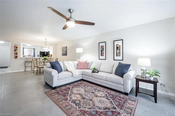 Living room featuring tile flooring and ceiling fan