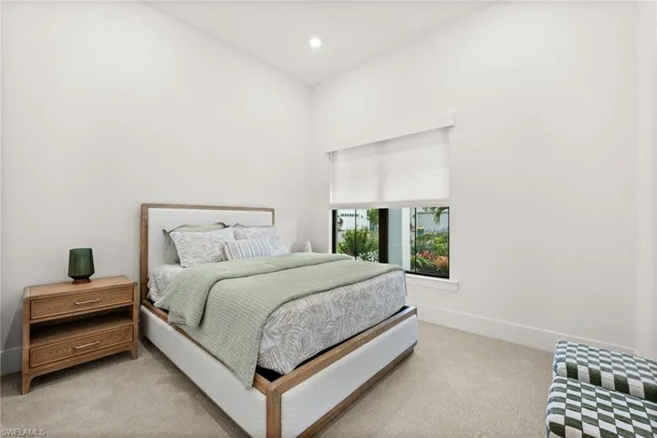 Bedroom featuring light carpet and recessed lighting