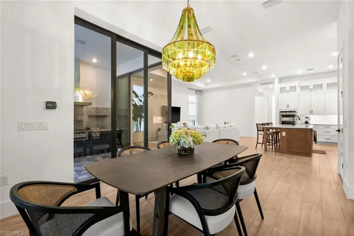Dining room featuring a chandelier, light wood-type flooring, and recessed lighting