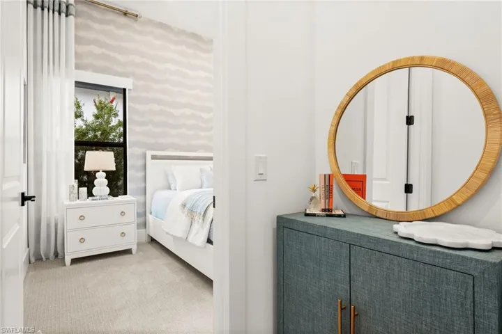 Bedroom with carpet and wallpapered walls
