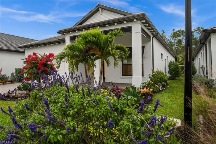View of home's exterior featuring stucco siding and a lawn