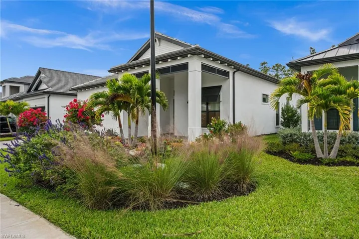 View of side of home with stucco siding and a lawn