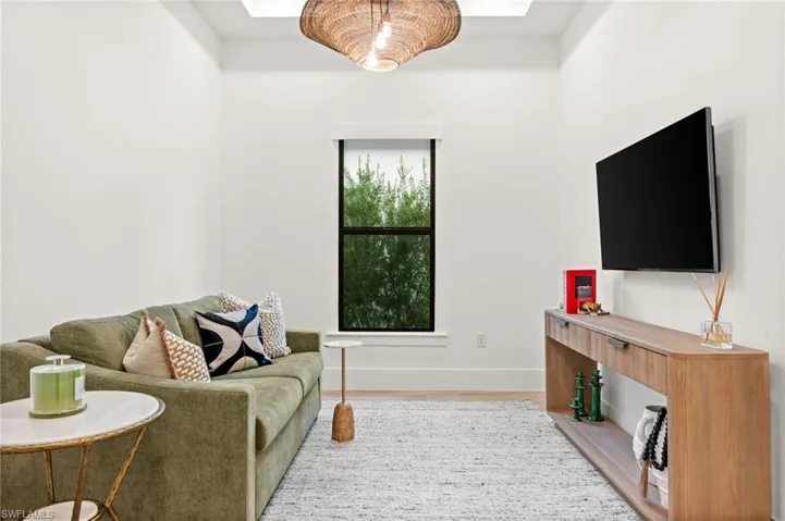 Living area with baseboards and wood finished floors