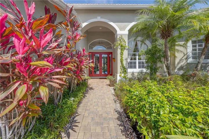 Entrance to property featuring stucco siding and french doors