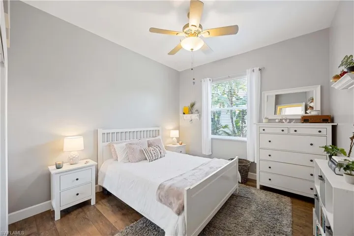 Bedroom featuring dark wood finished floors, baseboards, and ceiling fan