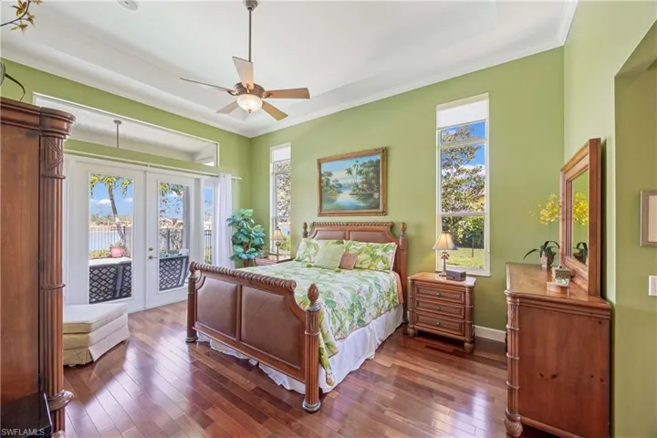 Master Bedroom featuring access to exterior, multiple windows, dark wood-type flooring, and french doors