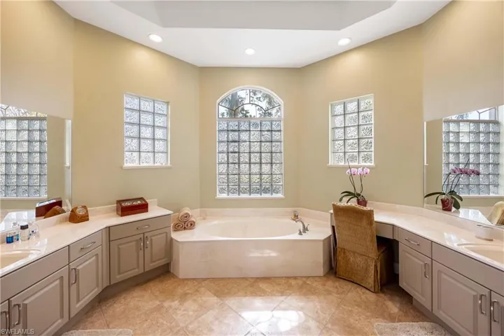 Master Bathroom featuring a garden tub, vanity, and recessed lighting