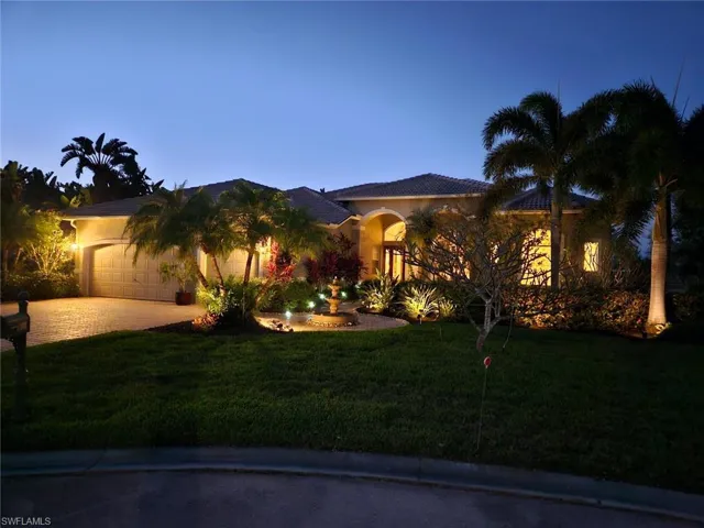 Mediterranean / spanish home with a garage, a front yard, decorative driveway, and stucco siding