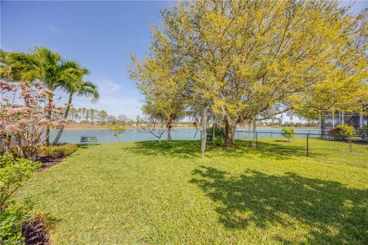 View of yard with a water view and fence