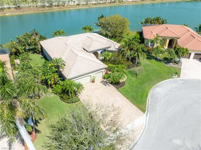 Birds eye view of property with a water view