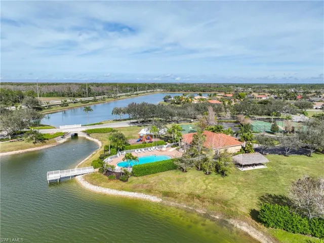 Birds eye view of property with a water view