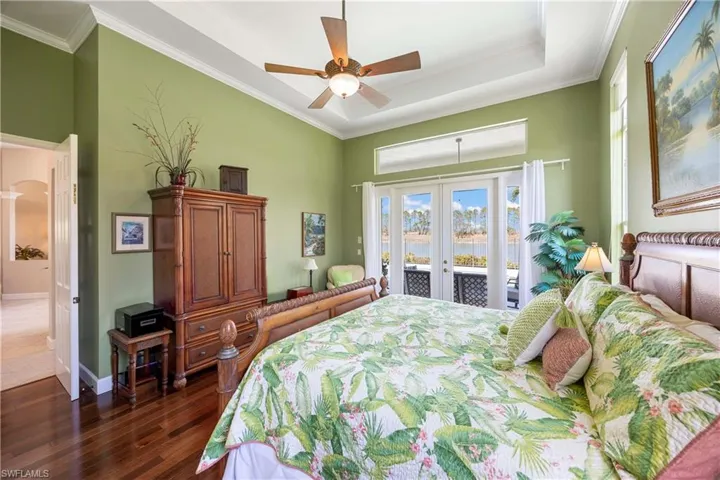 Master Bedroom with french doors, crown molding, dark wood-type flooring, access to outside, and baseboards