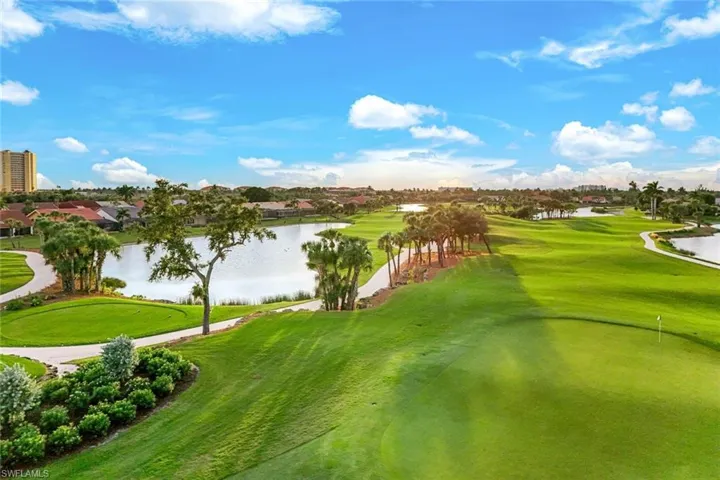 View of community with a water view, view of golf course, and a putting green