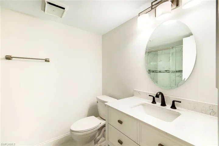 Full bathroom with vanity and a stall shower