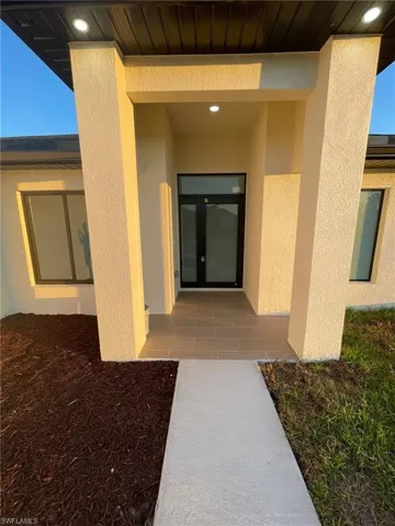 Property entrance featuring stucco siding