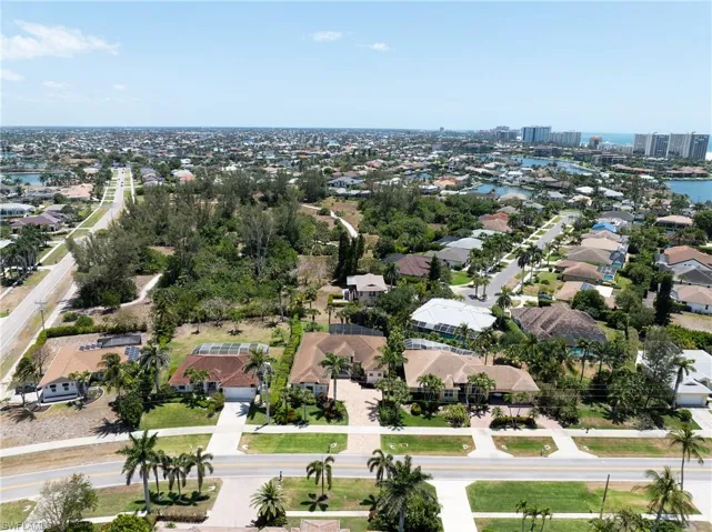 Birds eye view of property featuring a water view and a residential view
