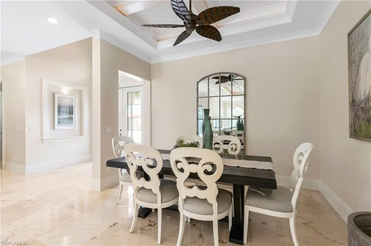 Dining room featuring ornamental molding, a healthy amount of sunlight, and ceiling fan