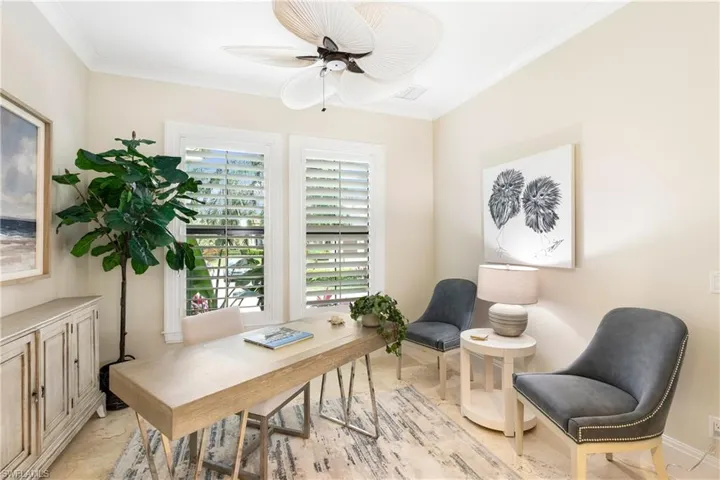 Office space with visible vents, ornamental molding, and a ceiling fan