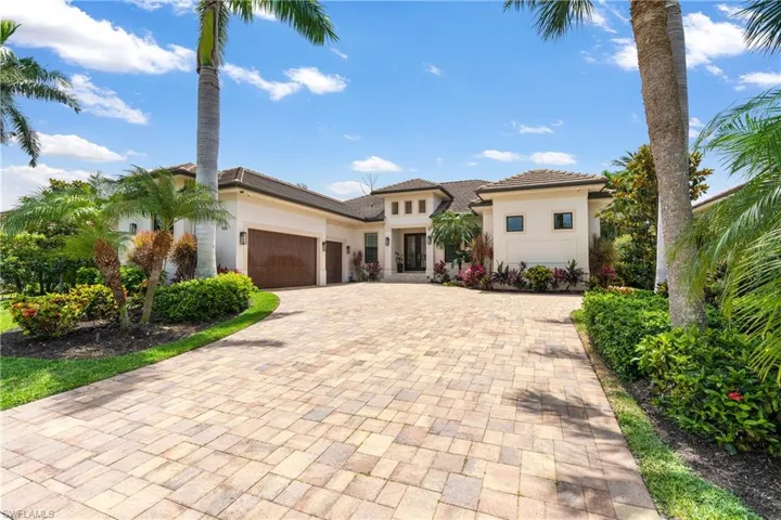 Mediterranean / spanish-style home with stucco siding, decorative driveway, a tiled roof, and an attached garage