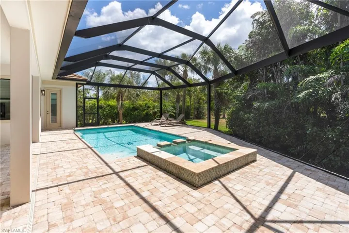 View of swimming pool with a patio, a lanai, and a pool with connected hot tub