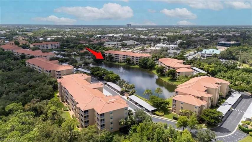 Bird's eye view of apartment complex and a nearby body of water