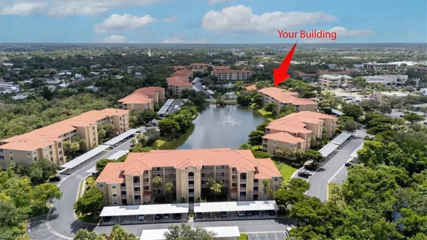 Bird's eye view of apartment complex and a nearby body of water
