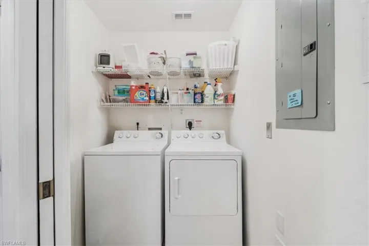 Laundry area with electric panel and independent washer and dryer