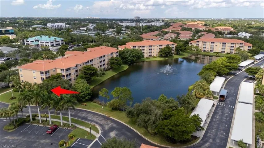 Aerial view of a nearby body of water and apartment complex / building