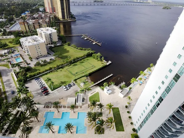 Aerial perspective showcasing multiple buildings, expansive waterfront, and extensive community amenities