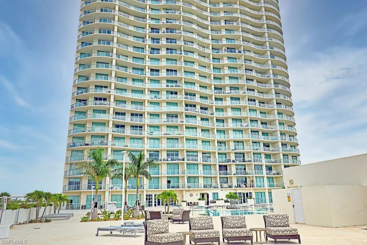 High-rise building with a curved façade and multiple private balconies