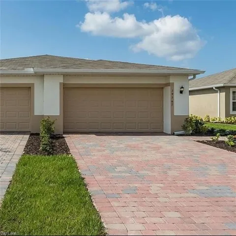 Garage featuring decorative driveway