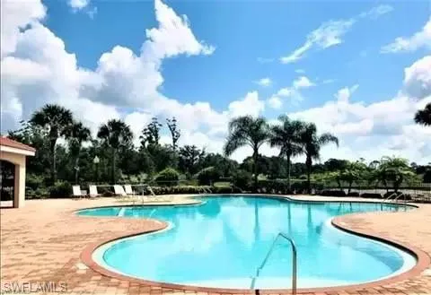 Community pool featuring a patio