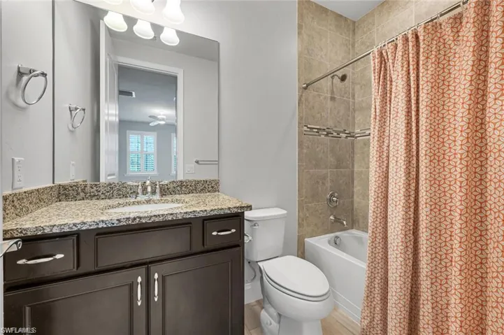 Full bath with vanity and shower / tub combo with curtain