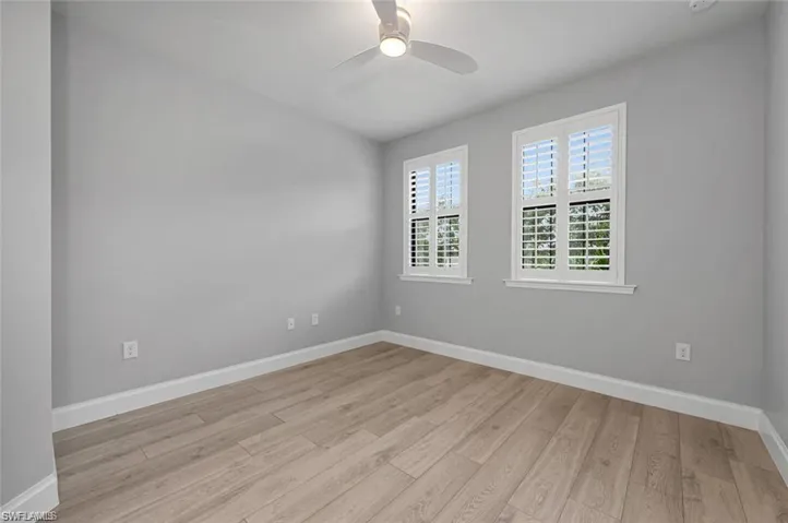 Unfurnished room with light wood-style floors and a ceiling fan