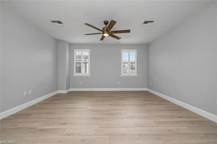 Spare room featuring a ceiling fan and light wood-style floors
