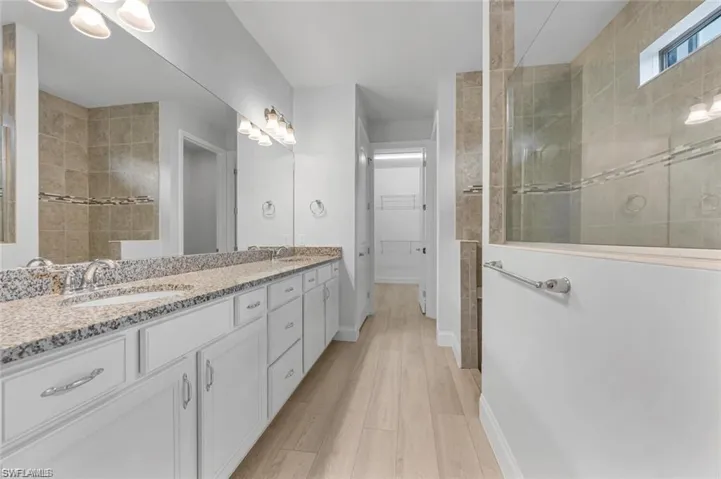 Full bath featuring Walk in Shower, Double Vanity,  and Walk in Closet
