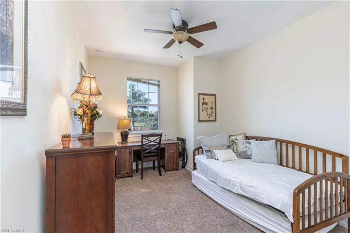 Third bedroom with a ceiling fan and carpet floors