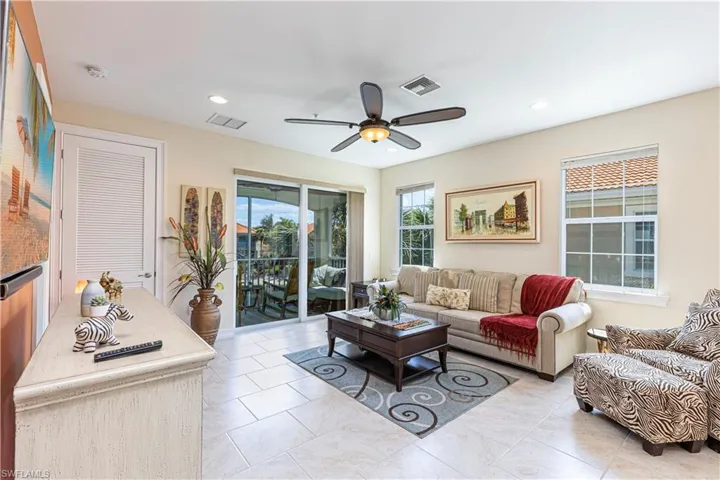 Living area featuring light tile patterned flooring, visible vents, recessed lighting, and a ceiling fan