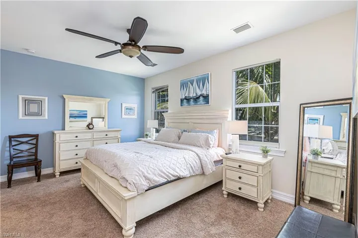 Bedroom featuring visible vents, ceiling fan, baseboards, and carpet
