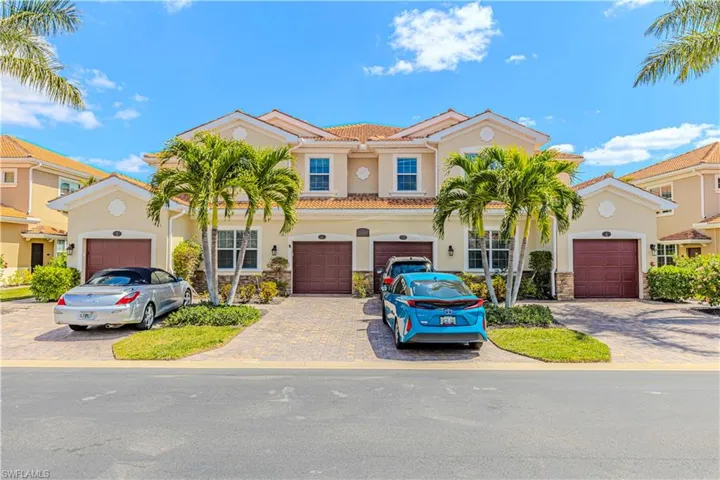 Mediterranean / spanish-style home featuring a tile roof, stucco siding, a garage, stone siding, and driveway