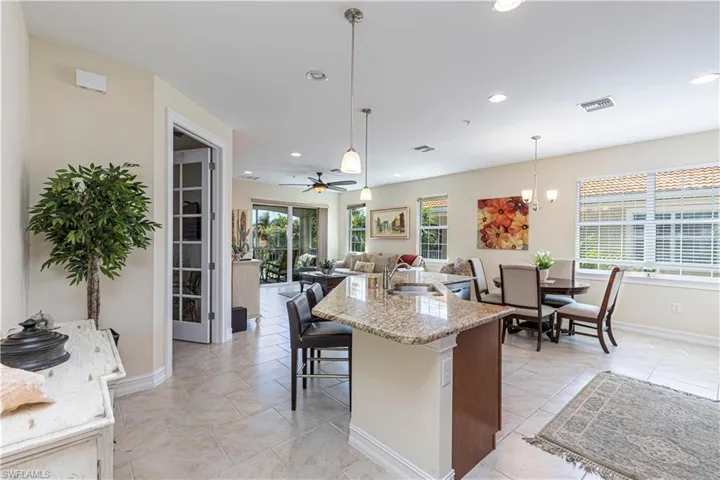Kitchen with hanging light fixtures, visible vents, recessed lighting, and a sink