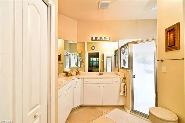 PRimary bathroom with dual sinks and water closet