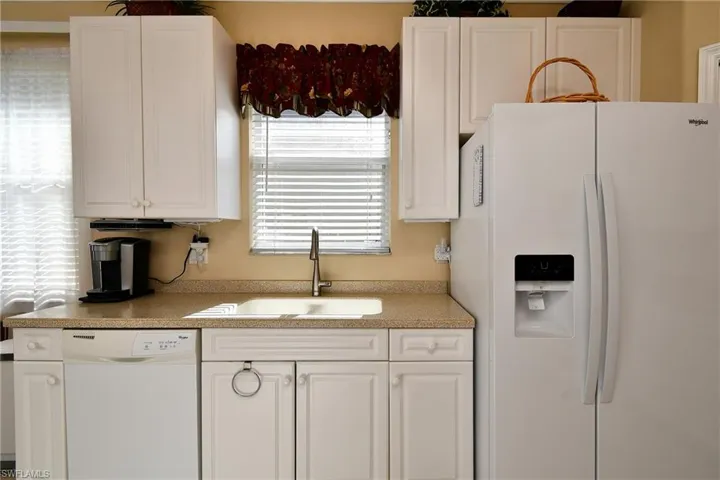 The kitchen features a large corner pantry