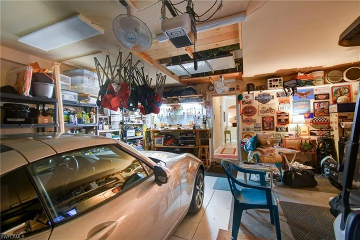 garage features A/C, insulated door, workbench, automated garage door screen and tons of storage