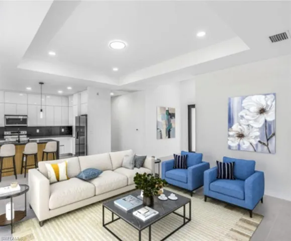 Living room featuring a tray ceiling and recessed lighting